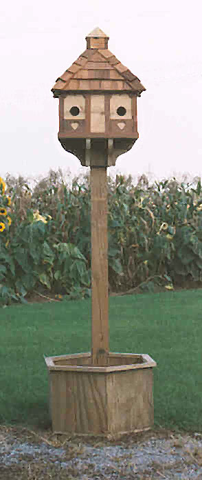 A hand crafted bird house with flower box